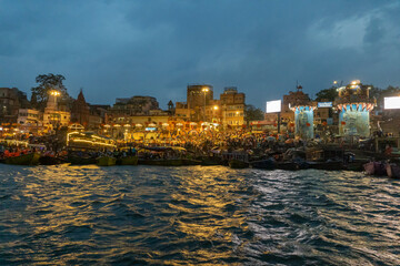 Fototapeta premium India Varanasi ganga ghat at night, view of the crowded banks of people and funeral pyres