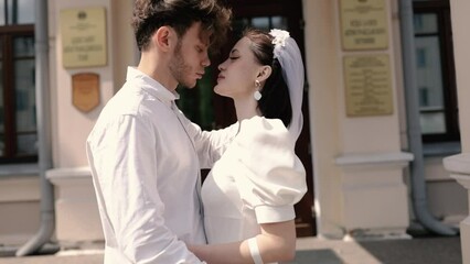 loving couple of newlyweds at the registry office kissing, the concept of marriage.