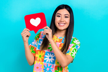 Photo of adorable sweet lady wear flower print t-shirt rising heart feedback card isolated blue color background