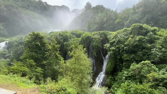 View of Marmore waterfall in Umbria region, Italy. Amazing cascade splashing into nature with trees and rocks