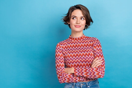 Photo portrait of lovely young lady folded arms look empty face dressed stylish striped clothes isolated on blue color background