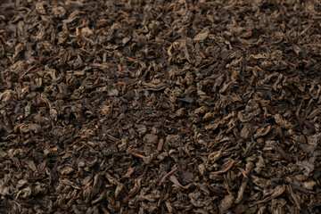 Dried tea leaves as a background.