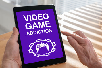 Video game addiction concept on a tablet
