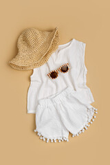 White Cotton T-shirt with shorts. Stylish baby clothes and accessories for summer. Fashion kids outfit. Flat lay, top view