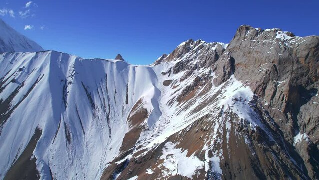 Aerial birds eye view Himalaya mountains snowy peaks and blue skies in sunny summer day. Majestic breathtaking spectacular landscape background in Asia