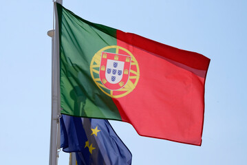 Portuguese national flag and flag of the European Union waving in the wind