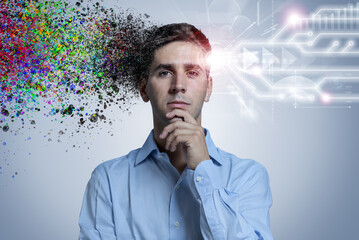 Portrait of pensive young man with colourful paint splatter and glowing circuit lines. Creative and...