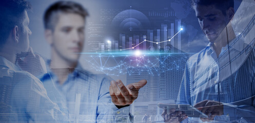 Finance analyst working with data graphs and digital tablet over dowtown buildings background. Double exposure, investment strategy concept