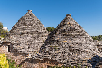 Scenic view of trulli whitewashed huts with conical roofs in Alberobello in Apulia in Italy 