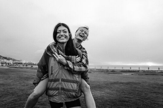Best friends enjoying a piggyback ride with smiles