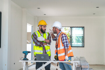 project engineer and a senior male contractor have different opinions about the construction of houses in the house being built.