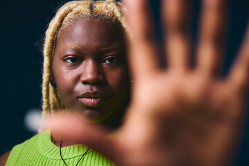 Portrait of lesbian woman holding hand closeup towards camera