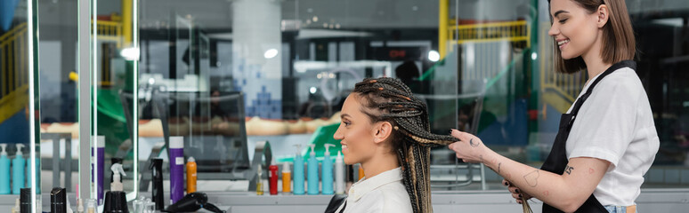side view, client satisfaction, hairdresser styling hair of female customer, looking at mirror, happy woman with braids, hairstyle, braided hair, beauty salon, hairstyling products, banner