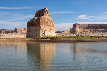 Panoramic view on solitary rock formations Lone Rock in Wahweap Bay in Lake Powell in Glen Canyon Recreation Area, Page, Utah, USA. Road trip to sand beach on wild campground in sunny summer. Vacay