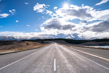 Obraz na płótnie Canvas A scenic landscape of road to Aoraki Mount Cook - Lake Pukaki with blue sky and clouds, South Island, New Zealand. View from Tekapo- Twizel Road.
