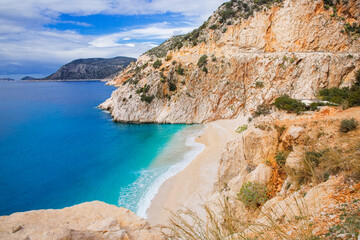 Beautiful bay with a beach and turquoise sea among big mountains. Kaputas beach, Kas, Türkiye. - obrazy, fototapety, plakaty