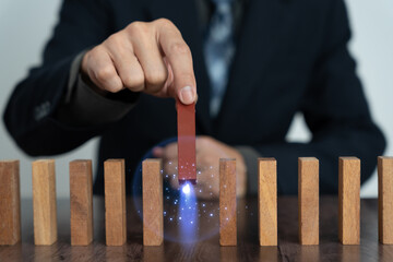 insurance with hands protect domino. Businessman hands stop dominoes falling in business crisis....