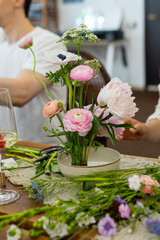 The process of creating a floral composition. Composition from kenzan. Floristic courses. Study of floristry. Rest and relaxation while creating bouquets from farm flowers.