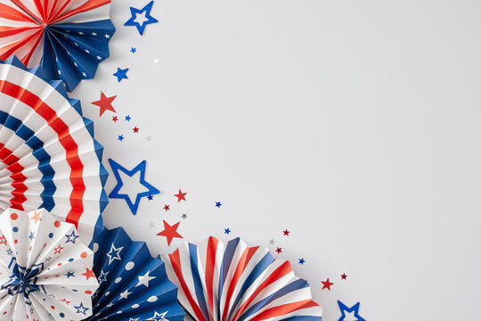 America's Independence Day festivities concept. Top view flat lay of patriotic paper props, red, blue, white stars on white background with empty space for advert or text