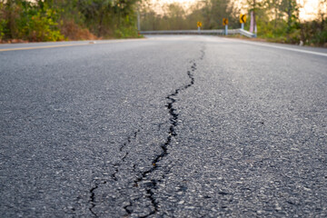 Broken asphalt roads, caused by sub-standard construction, corruption