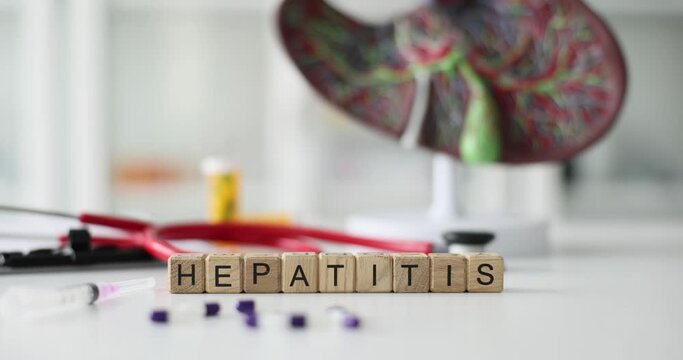 Wooden cubes with the inscription hepatitis, close-up. Medicine, concept health, slowmotion