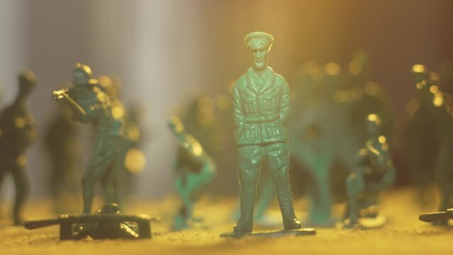 Toy soldiers take the battlefield with charged-up weaponry and spotlight imitation. Violence war resistance and peace without armored invasion