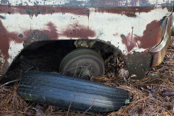 Old rusty car in a junk yard