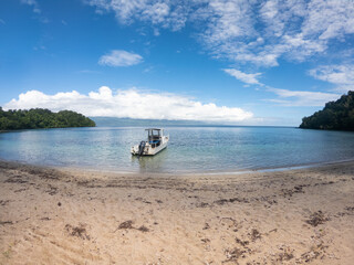 Boat moored near sandy beach at Waitatavi Bay, Fiji