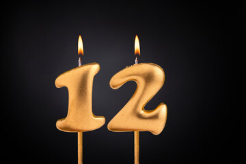 Golden candle 12 with flame - Birthday card on dark luxury background