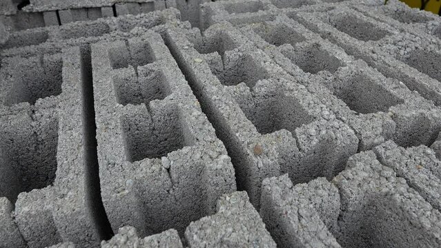 Stack of concrete bricks blocks on the palette at warehouse close up