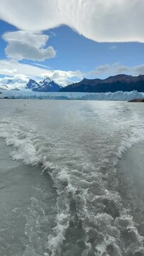 View of the Perito Moreno Glacier from a boat, vertical video of the Perito Moreno Glacier in Argentine Patagonia. Concept of vacations and travel