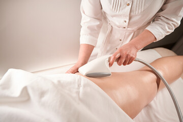 Obraz na płótnie Canvas Specialist masseur makes a hardware foot massage for a client