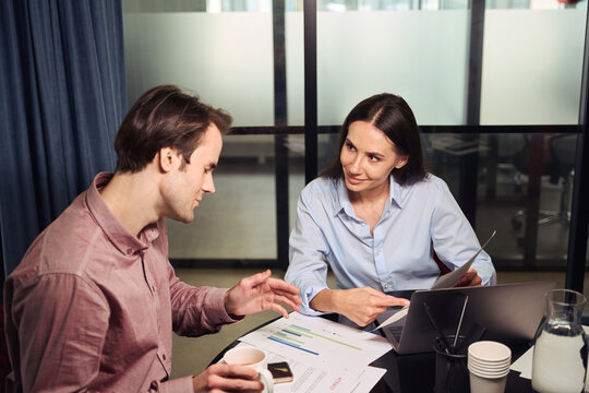 Two corporate workers dealing with business documentation
