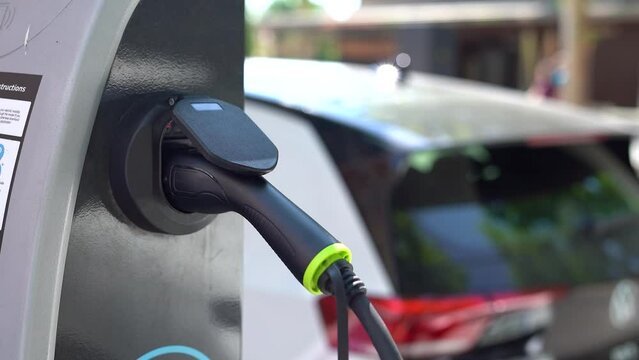 Electric charging station close-up on the background of the car