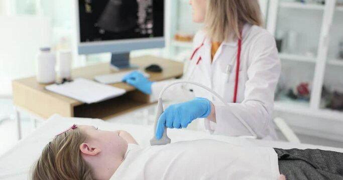 The doctor makes the child an ultrasound of the heart, close-up. Diagnosis of vascular diseases, slowmotion