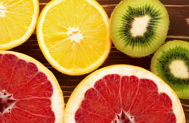 Fototapeta na wymiar background of round citrus fruits, orange, grapefruit and kiwi