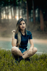 Young man relaxing at sunset with legs crossed. with loose hair in a serene setting in the midst of nature.