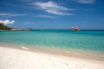 Obraz premium Cea beach with the Red Rocks, the Red Rocks - Faraglioni. White sand and crystal clear water. Tortoli, Ogliastra, Sardinia, Italy