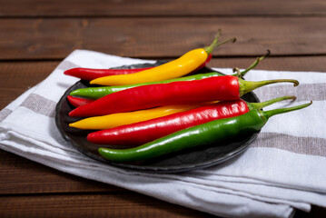 Fresh chili pepper on a black plate