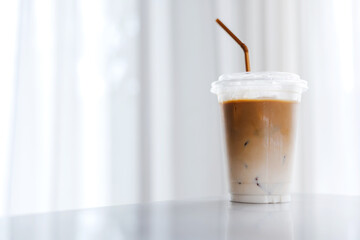 Plastic takeaway cups of delicious iced coffee on table in cafe , There is space for text in the...