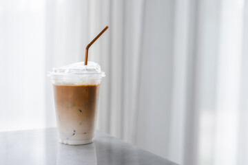 Plastic takeaway cups of delicious iced coffee on table in cafe , There is space for text in the background , 