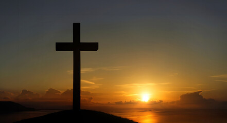 The cross standing on mountain sunset and flare background. Cross on a hill as the morning sun...