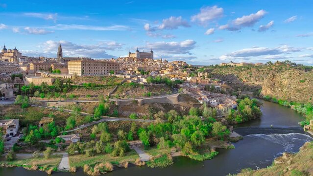 Panoramic of the city of Toledo with accelerated time and moving clouds a beautiful sunny day with blue sky and clouds.