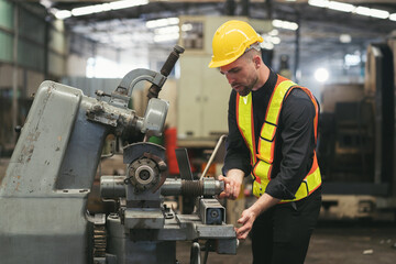 Male engineer worker working and inspecting parts quality of lathe machine in industry factory, wearing safety uniform, helmet. Male technician worker maintenance parts of machine in workshop - Powered by Adobe