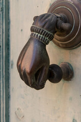 door hand knocker on old wooden door