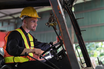 Male factory worker driving and operating on forklift truck in factory. Male engineer driving and operating on forklift truck in plant © amorn