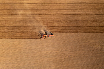Drone photography of agricultural machinery working in cultivated field