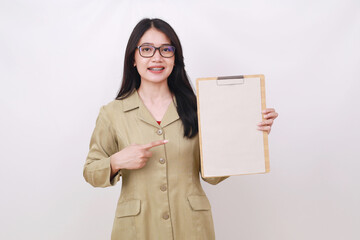 Happy young pretty teacher holding clipboard and pointing on it