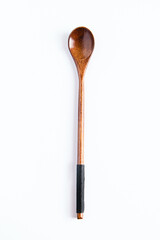 Wooden spoon with long handle on white background. Kitchen utensils for cooking.