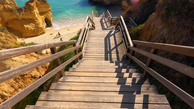 View of idyllic nature landscape with rocky cliff shore and waves crashing on. Camillo beach in Lagos. West Atlantic coast of Algarve region, south of Portugal.